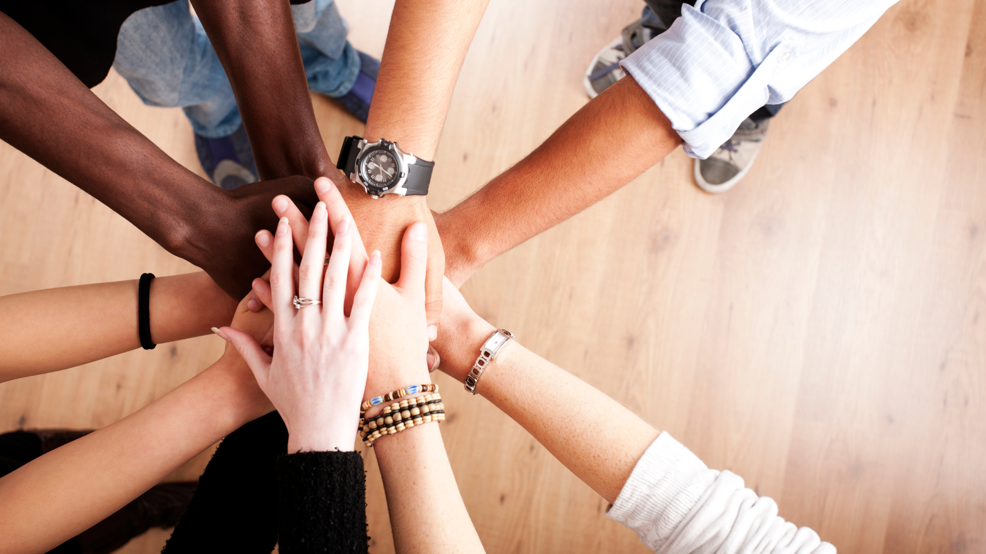 People stacking their hands in a circle