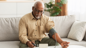 Man checking his blood pressure at home