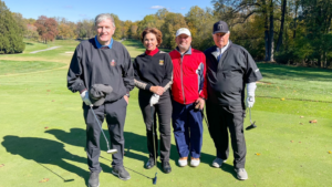 Four people on a golf course