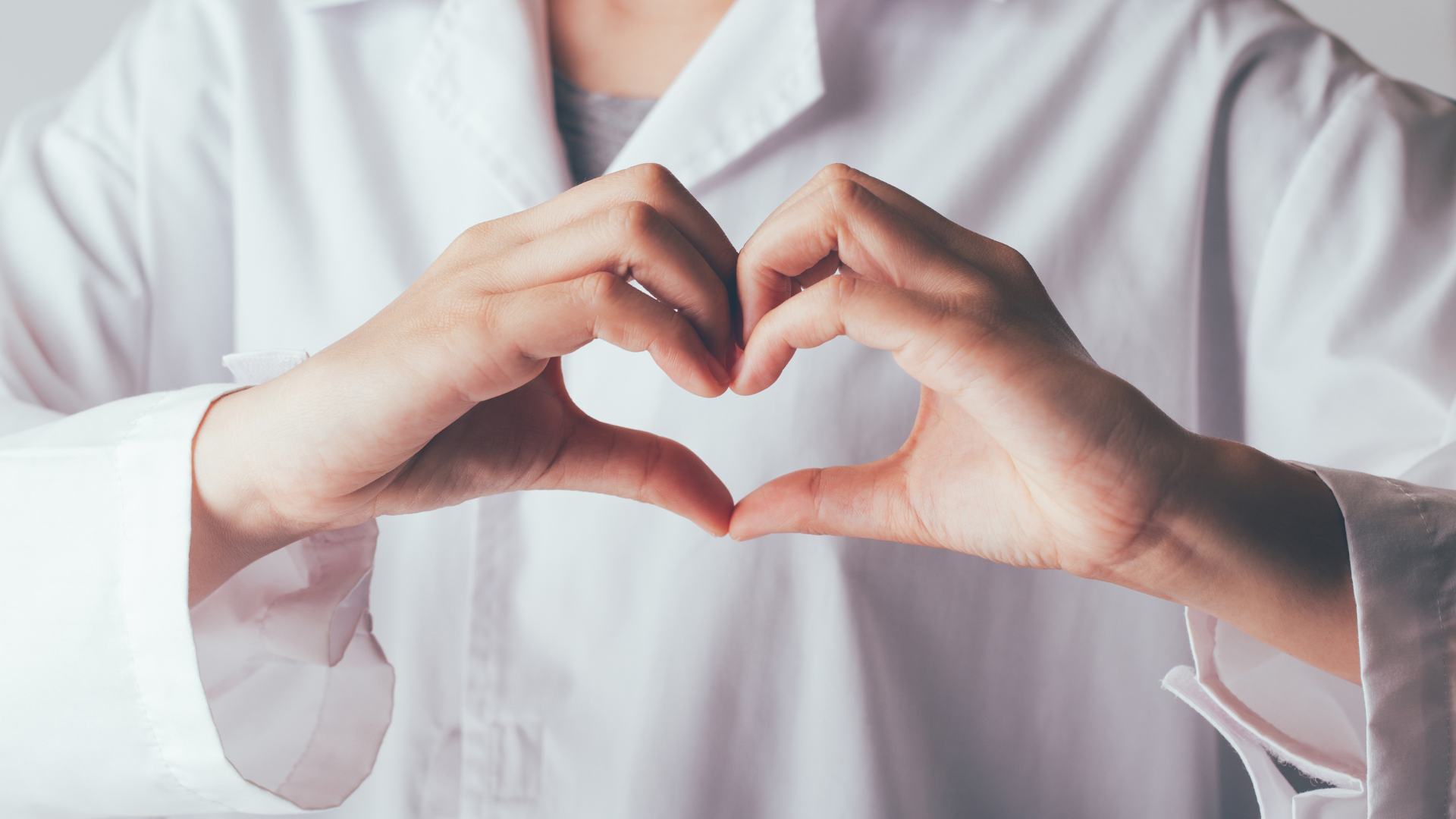 Doctor forming a heart with their hands.