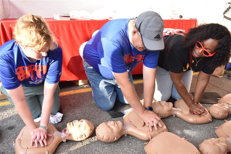 Two people learn Hands-Only CPR from an instructor