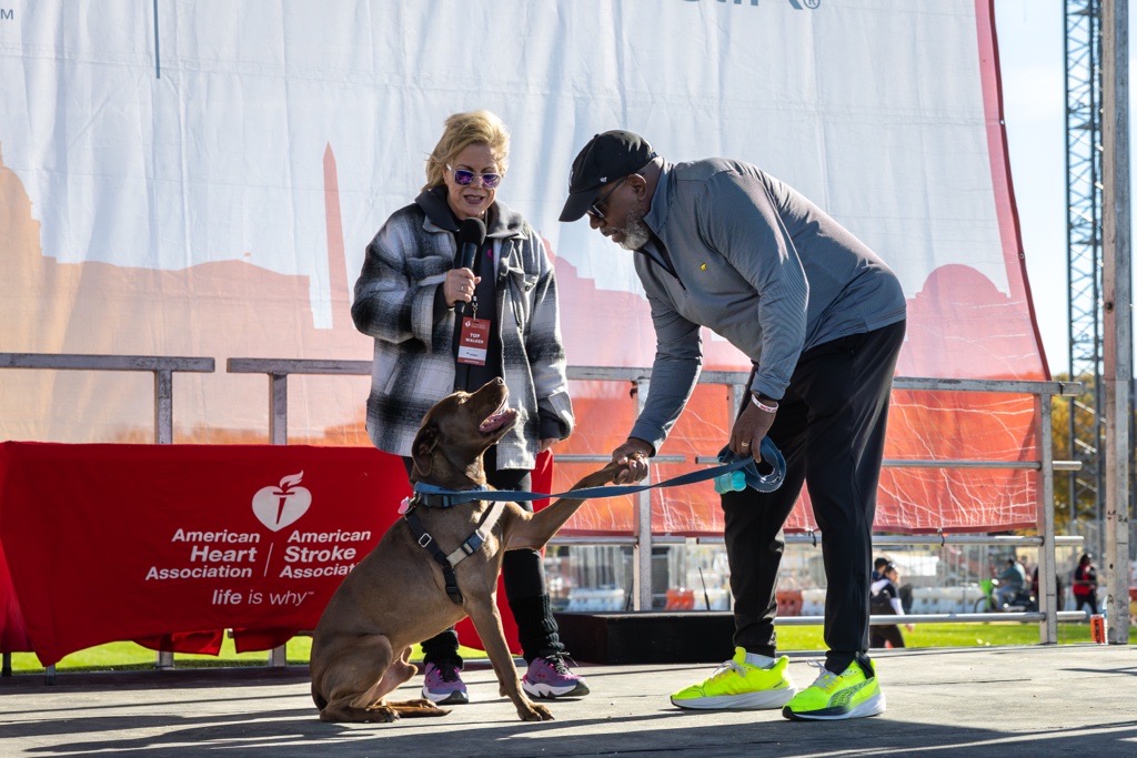 a woman, man and dog on stage