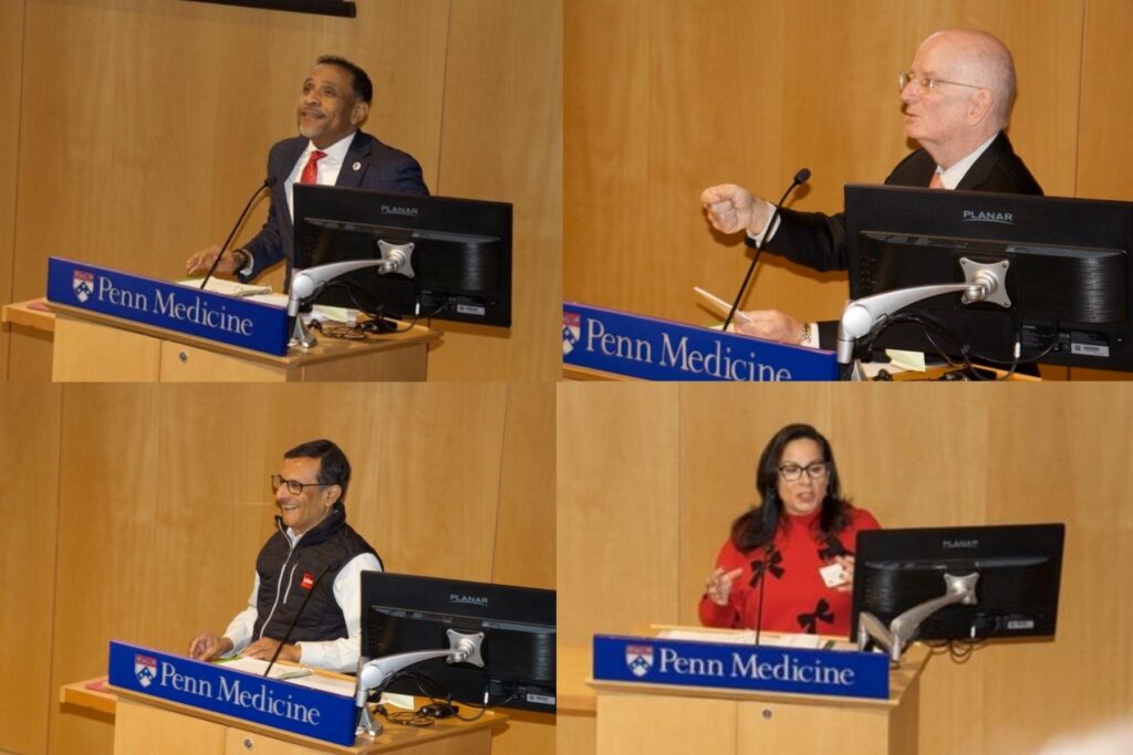 four speakers at the podium