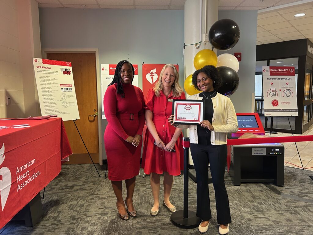three women posing with a certificate