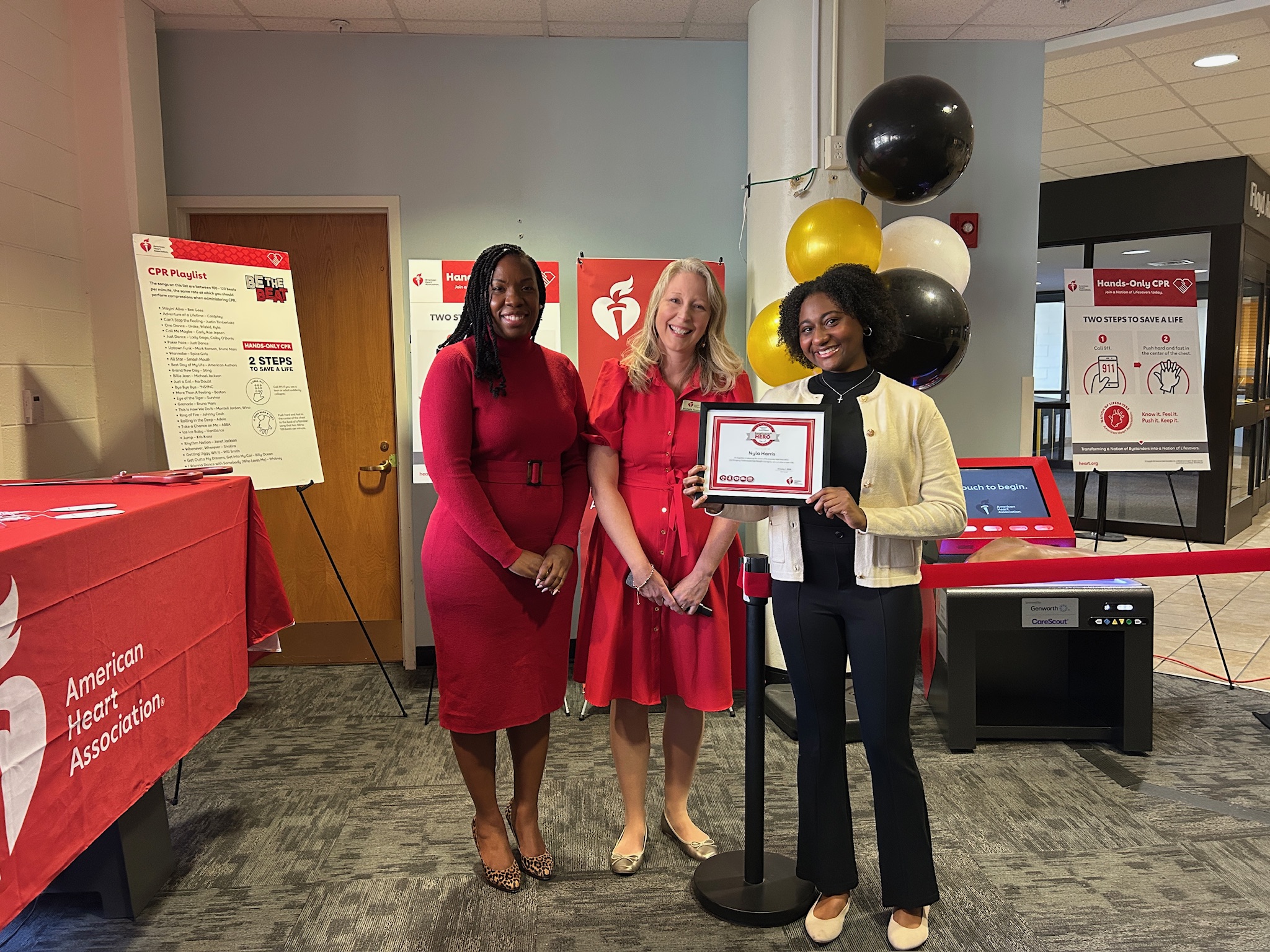 three women posing with a certificate