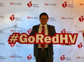 Dr. Sunny Intwala is pictured with a #GoRedHV sign