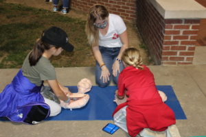 High school football fans take time out to learn Hands-Only CPR