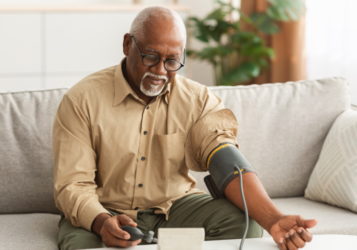 Man checking his blood pressure at home