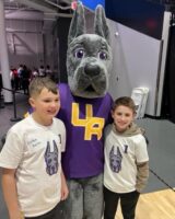 Cardiac Kids Colton Berlin, left, and Connor Daddario enjoy time with the UAlbany mascot on Saturday, Jan. 20. 