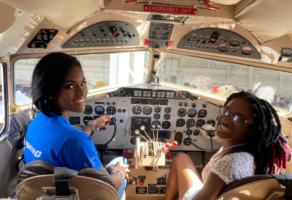 Two women in plan cockpit